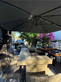 a view of a chairs and table under an umbrella in patio