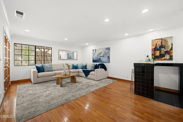 a kitchen with granite countertop white cabinets and refrigerator