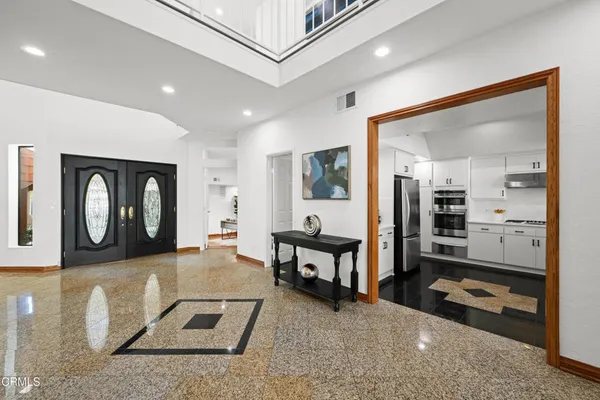 a spacious bedroom with a bed and a large window