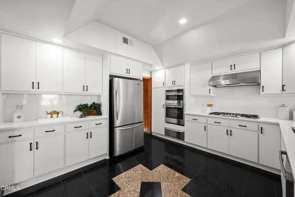 a spacious bedroom with a bed and a couch