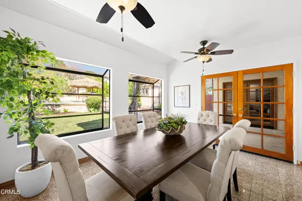 a bedroom with a bed and a potted plant on dresser