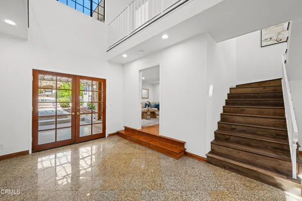 a bedroom with a large bed and a large window