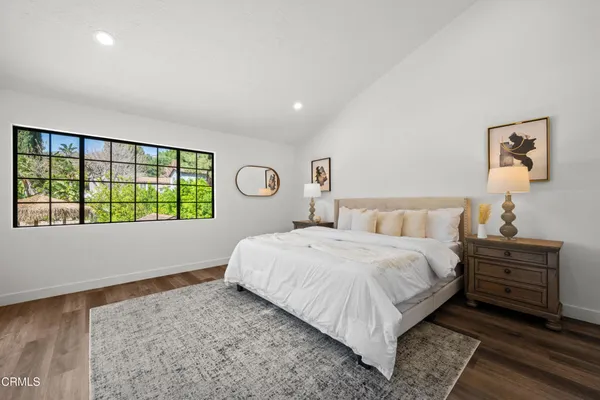 a bedroom with a bed and a chair