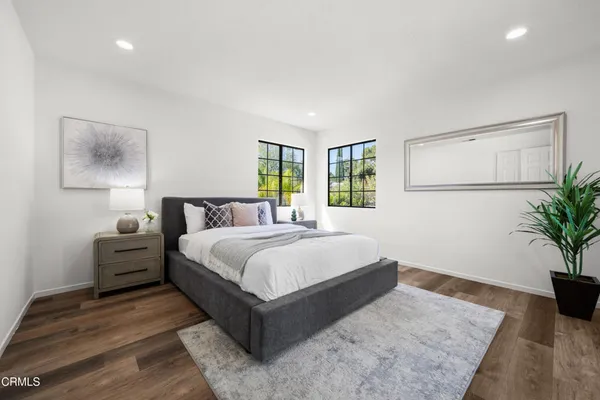 a view of a balcony with couches and wooden floor