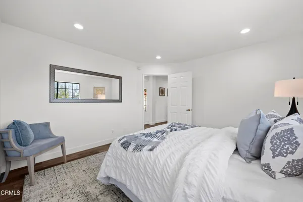 a bathroom with a shower sink vanity mirror and toilet