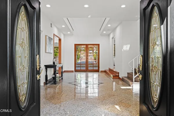 a living room with furniture a fireplace and a floor to ceiling window