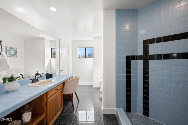a view of backyard with table and chairs under an umbrella with large trees