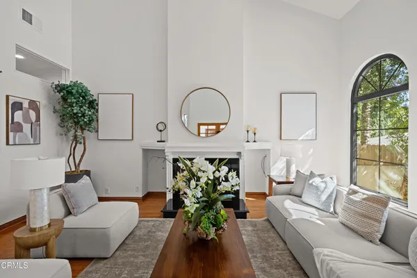 a dining room with furniture potted plants and wooden floor