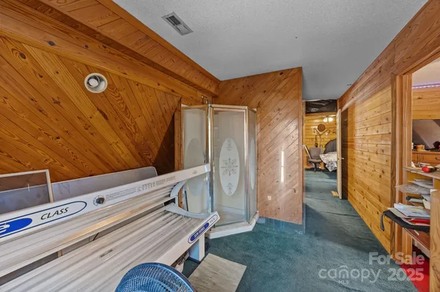 a bedroom with a bed mirror and window