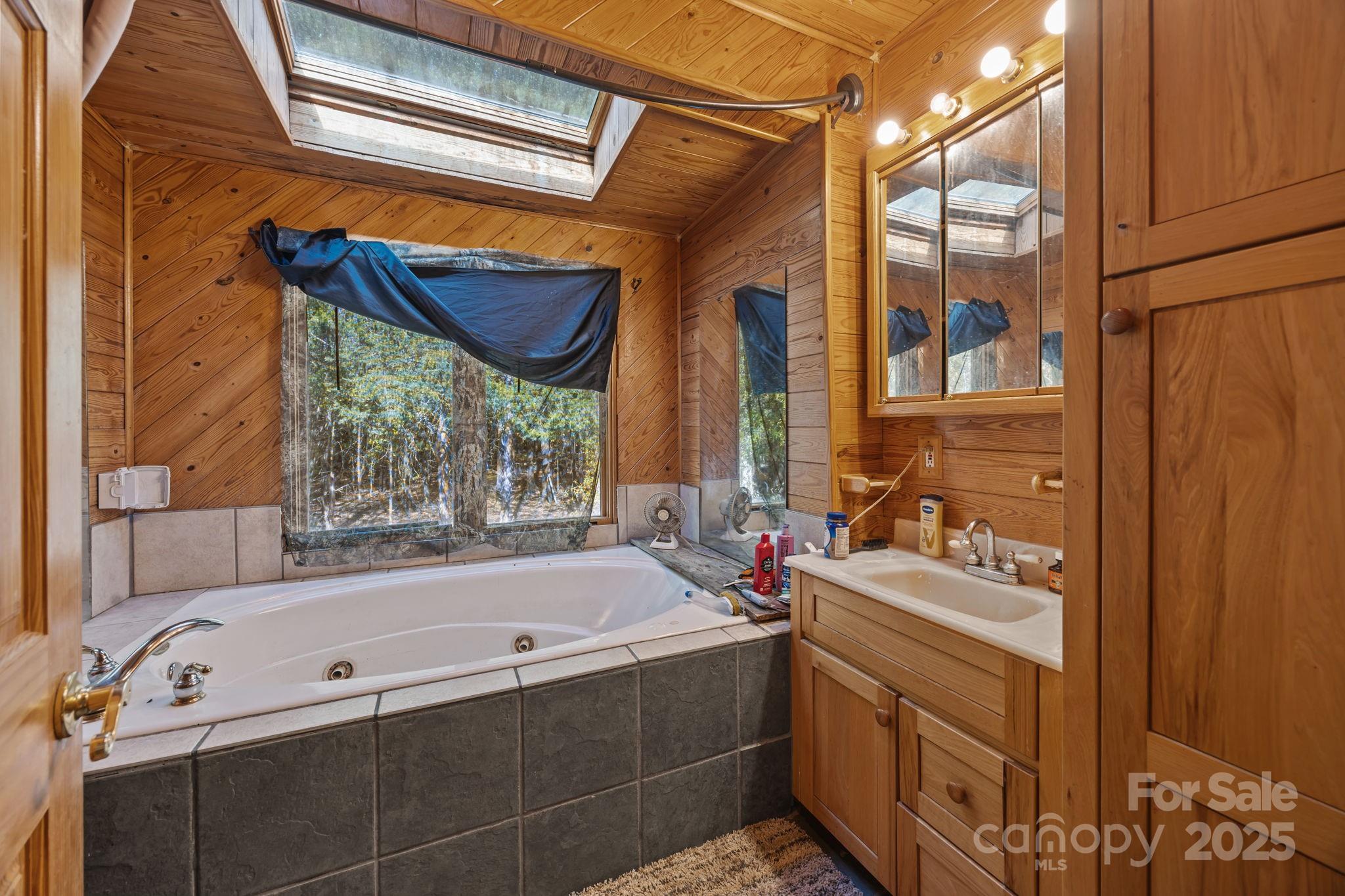 3178 Foxford Road Concord, NC 28025 - Photo 13 of 48 a bathroom with a tub sink and mirror