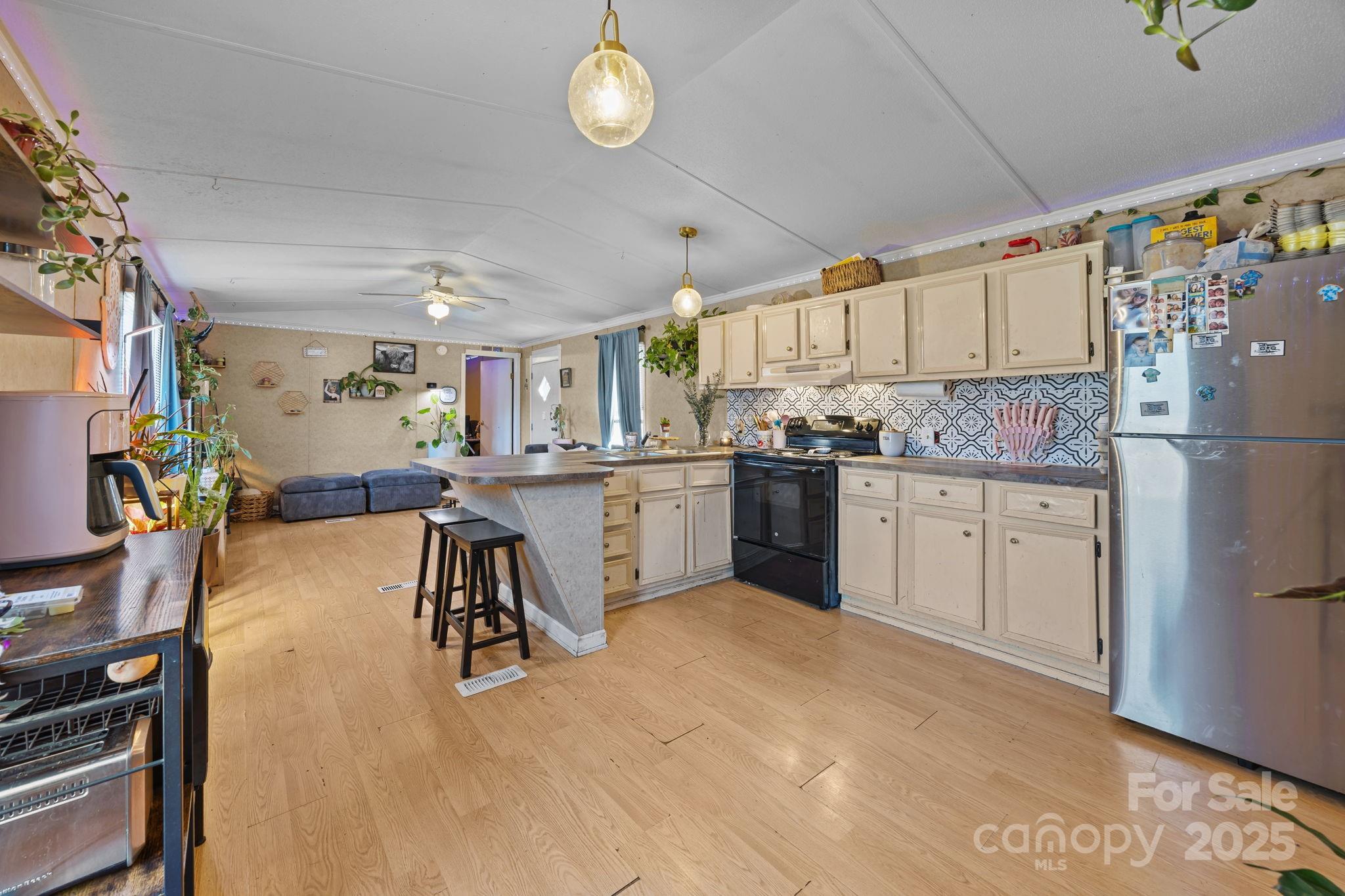 3178 Foxford Road Concord, NC 28025 - Photo 22 of 48 a kitchen with a refrigerator a sink and cabinets