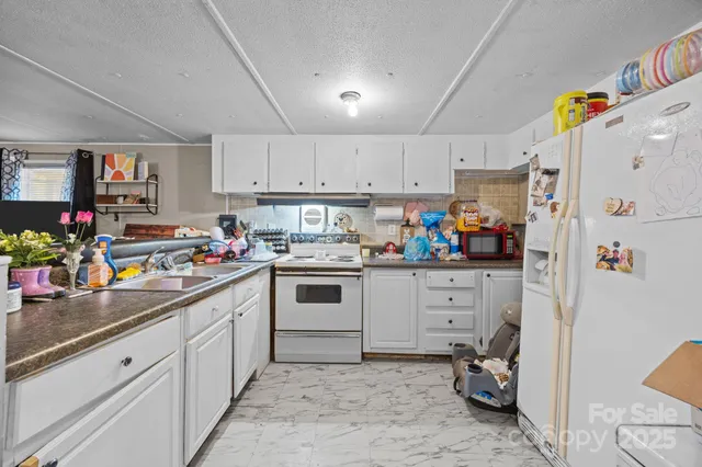 a bathroom with a sink toilet vanity and shower