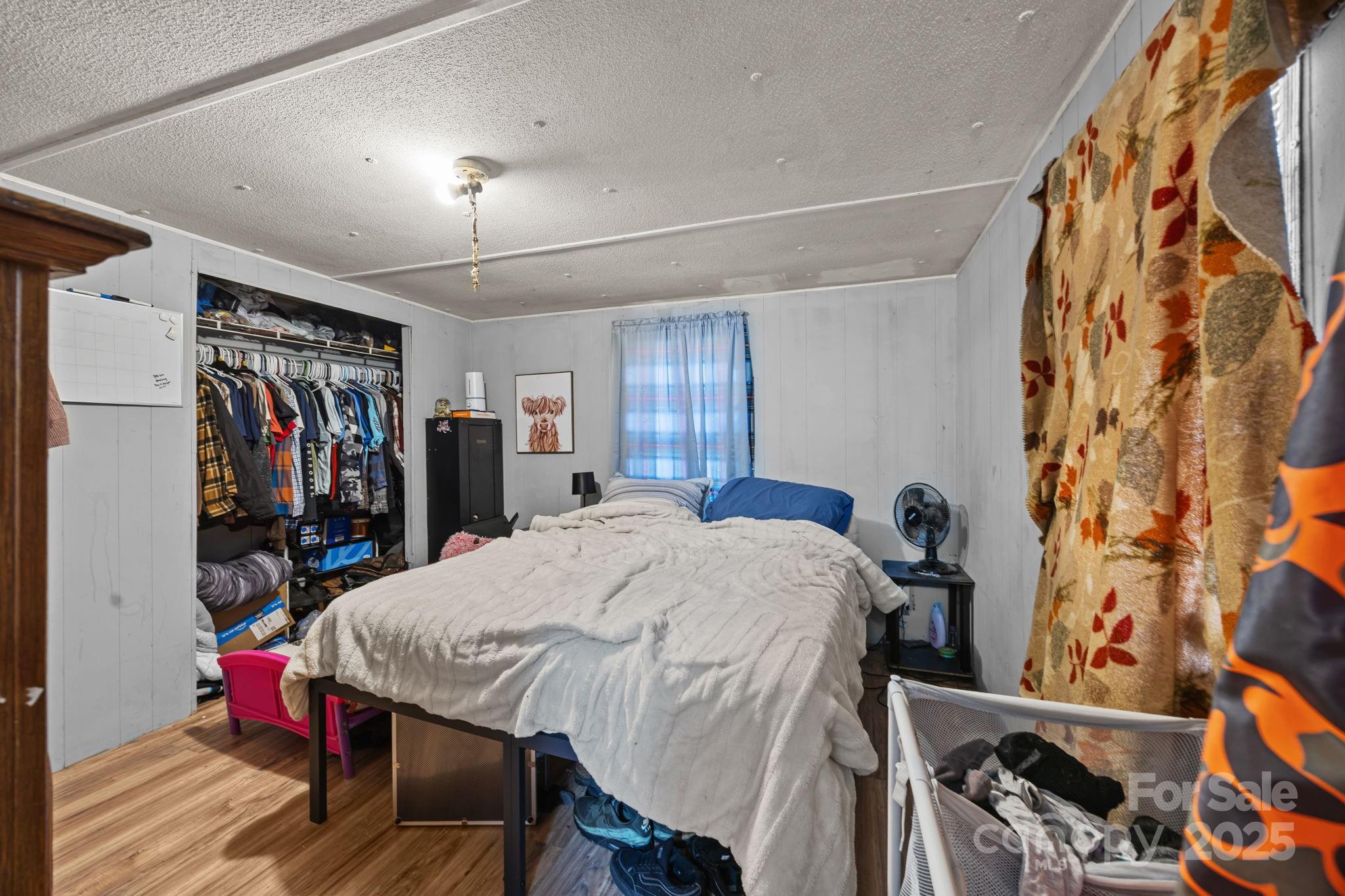 3178 Foxford Road Concord, NC 28025 - Photo 32 of 48 a bed room with a bed and a walk in closet