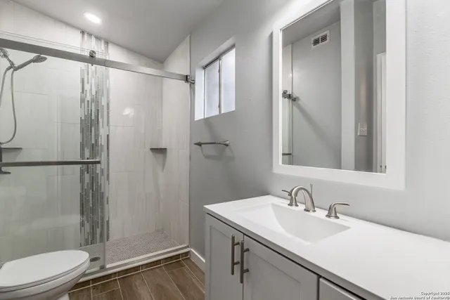 a bathroom with a sink toilet and shower