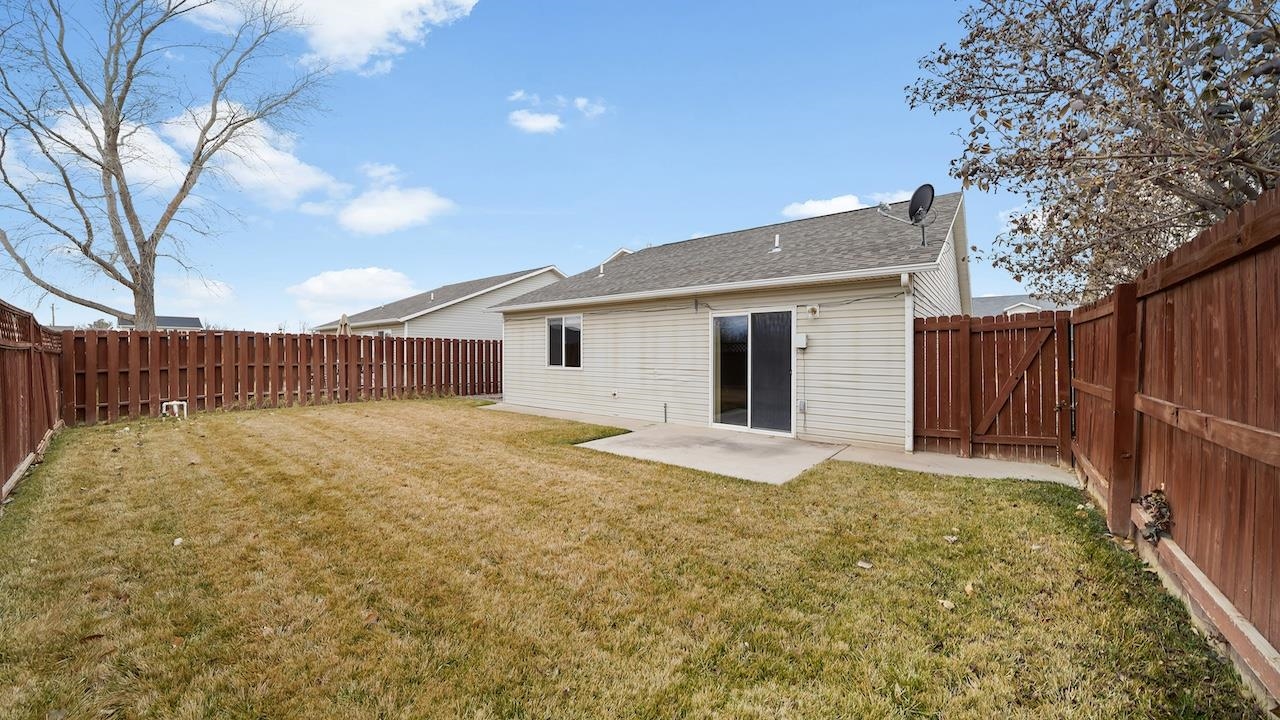 658 Springbrook Drive Grand Junction, CO 81504 - Photo 18 of 27 a view of a backyard with wooden fence