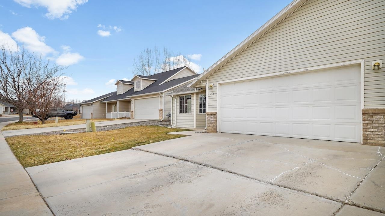 658 Springbrook Drive Grand Junction, CO 81504 - Photo 25 of 27 a view of a house with a yard and large tree