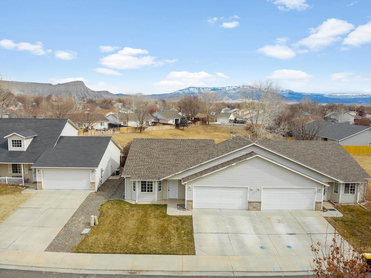 658 Springbrook Drive Grand Junction, CO 81504 - Photo 3 of 27 a view of a big house with a big yard and large tree