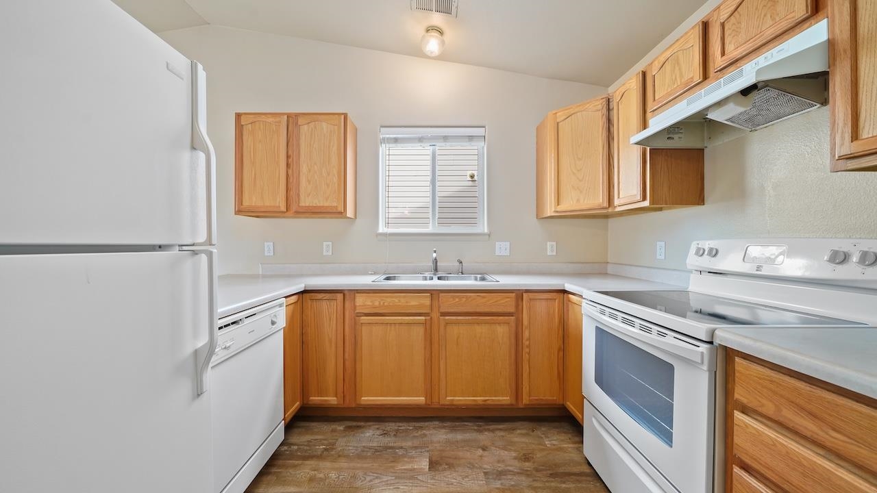 658 Springbrook Drive Grand Junction, CO 81504 - Photo 8 of 27 a kitchen with stainless steel appliances granite countertop a sink stove and refrigerator