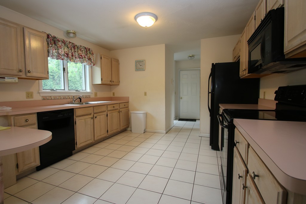 1 Lamplighters Way Saugus, MA 01906 - Photo 4 of 19 a kitchen with stainless steel appliances a sink a stove a refrigerator cabinets and a window