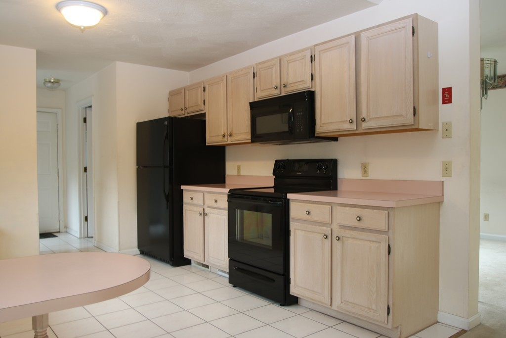 1 Lamplighters Way Saugus, MA 01906 - Photo 7 of 19 a kitchen with stainless steel appliances granite countertop white cabinets and refrigerator