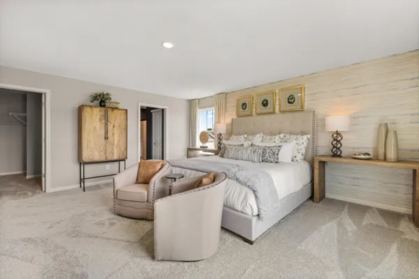 a spacious bedroom with a bed and window