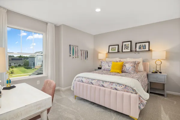 a bedroom with a bed and a large window