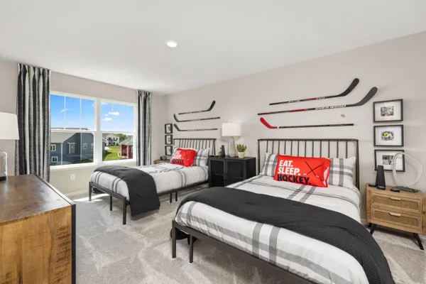 a bedroom with two beds and a large window