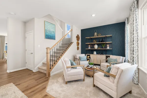 a living room with furniture or stairs and a wooden floor