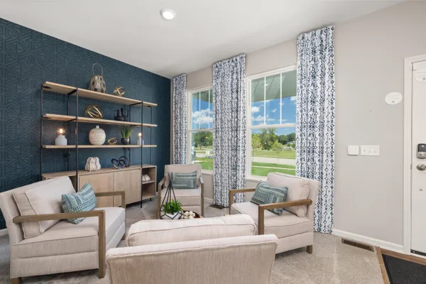 a living room with furniture and a book shelf