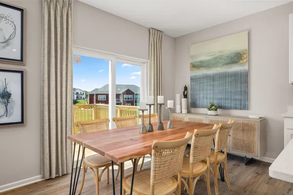 a dining room with furniture and window