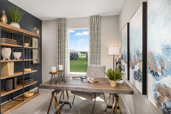 a view of a workspace with furniture and window