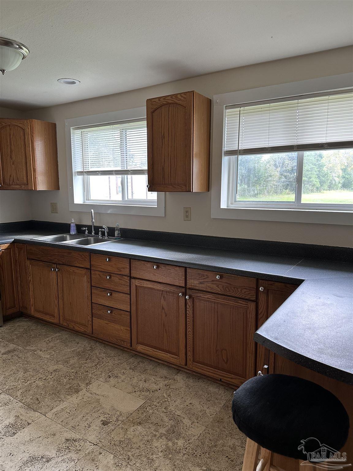 1052 Well Line Road Cantonment, FL 32533 - Photo 14 of 18 a kitchen with a sink and a window