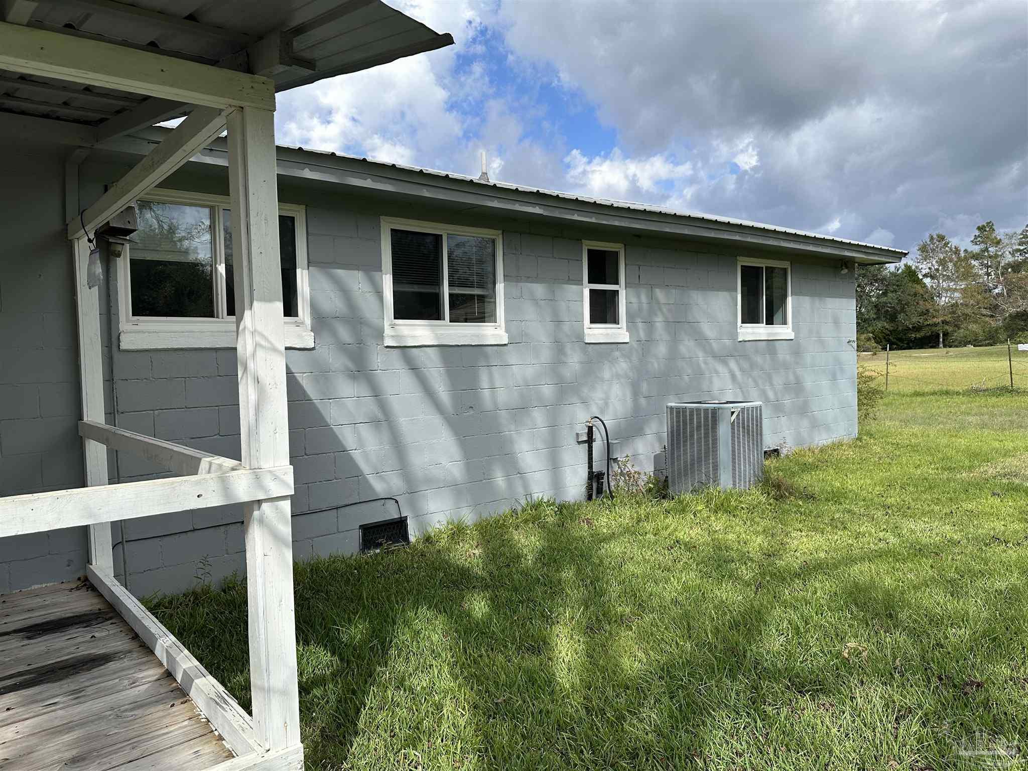 1052 Well Line Road Cantonment, FL 32533 - Photo 17 of 18 a front view of a house with garden