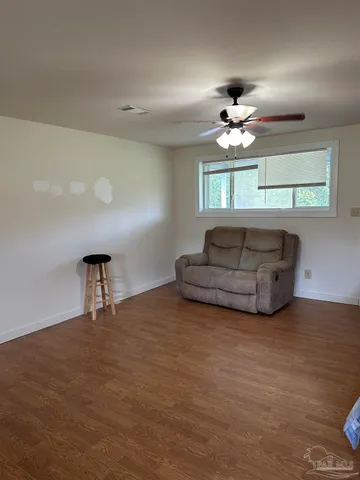 a living room with furniture a chandelier and a window