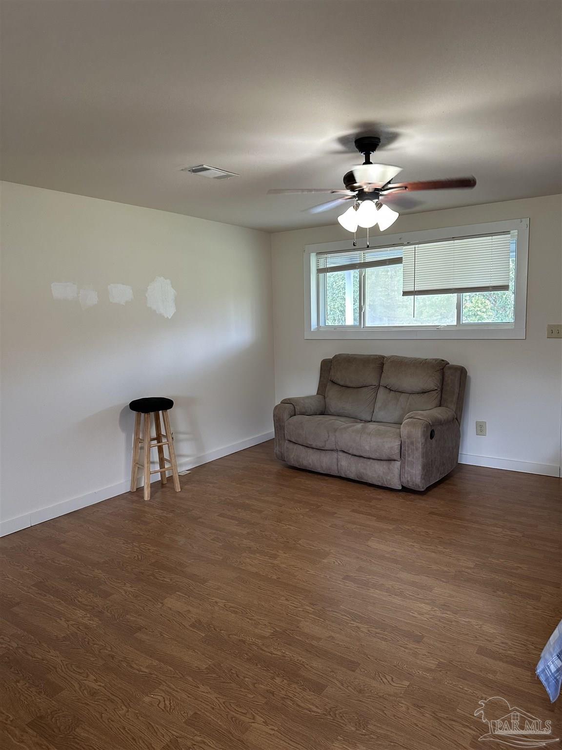 1052 Well Line Road Cantonment, FL 32533 - Photo 5 of 18 a living room with furniture a chandelier and a window