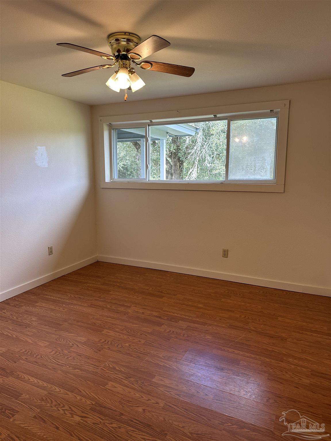 1052 Well Line Road Cantonment, FL 32533 - Photo 8 of 18 a view of a room with a window and a ceiling fan