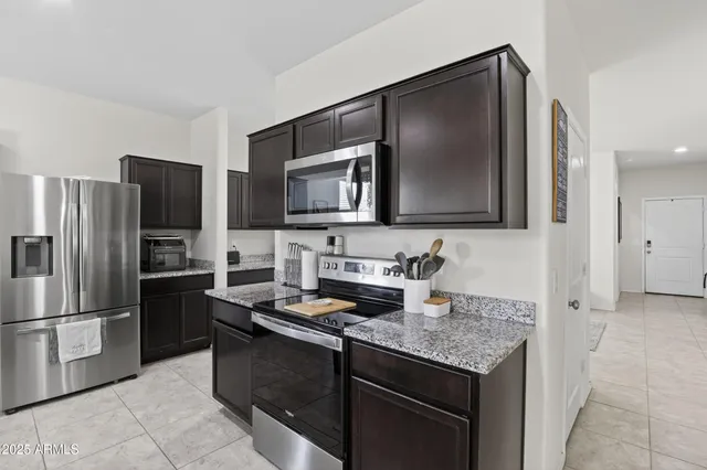 a kitchen with a refrigerator and a sink