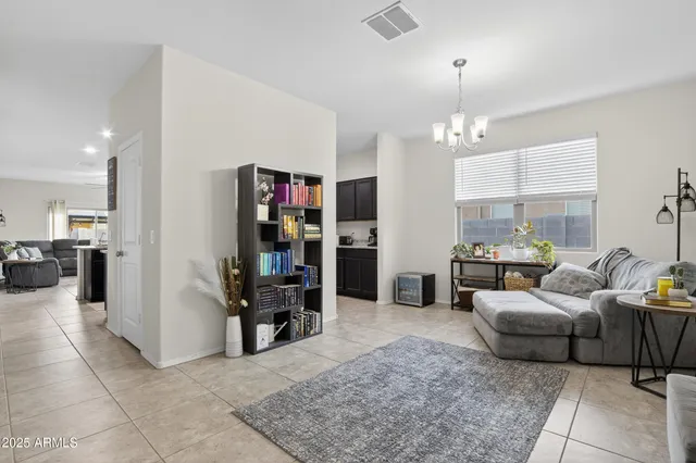 a living room with furniture and a bookshelf