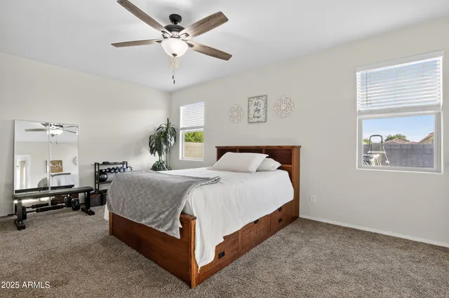 a bedroom with a bed and a chandelier