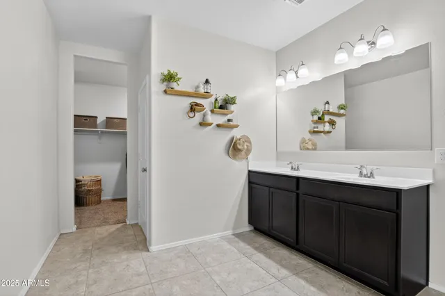 a spacious bathroom with a double vanity sink double and mirror