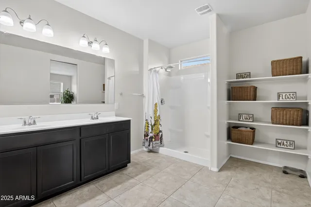 a spacious bathroom with a double vanity sink double and mirror