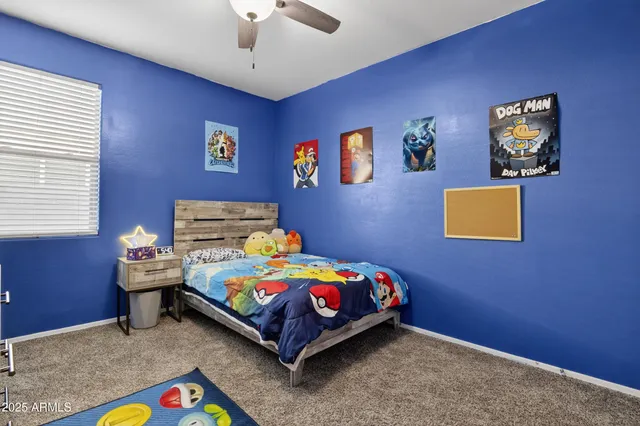 a bedroom with bed and painting on the wall