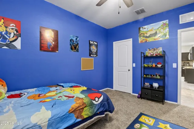 a bathroom with a granite countertop sink a toilet and a large mirror
