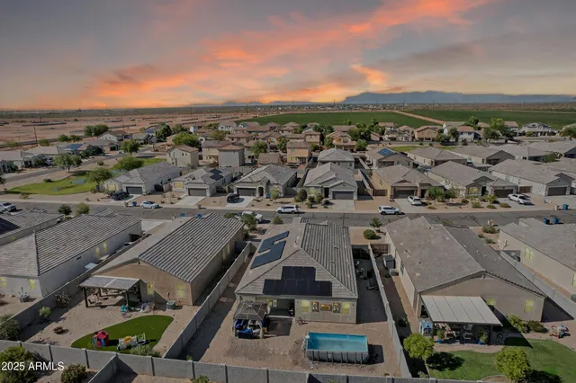 a view of a house with a wooden fence