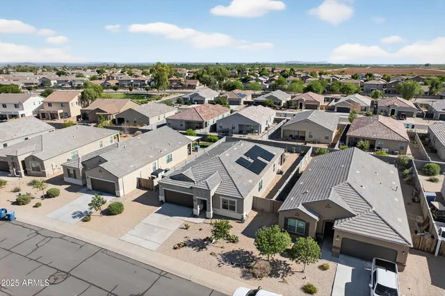 an aerial view of a house with a yard