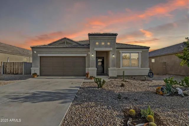 a view of a house with a backyard and a tree