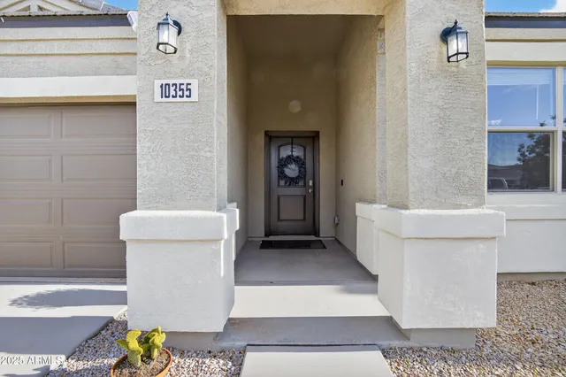 a living room with furniture and a view of kitchen