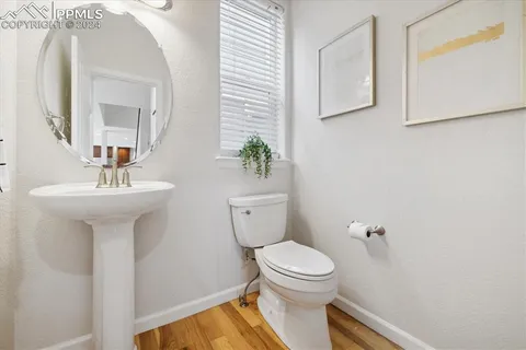 a bathroom with a sink toilet and a mirror