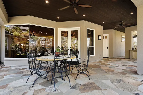 a view of a porch with a table and chairs