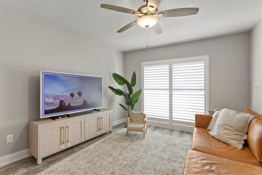 6712 Jennifer Drive Temple Terrace, FL 33617 - Photo 12 of 30 a living room with furniture and a large window